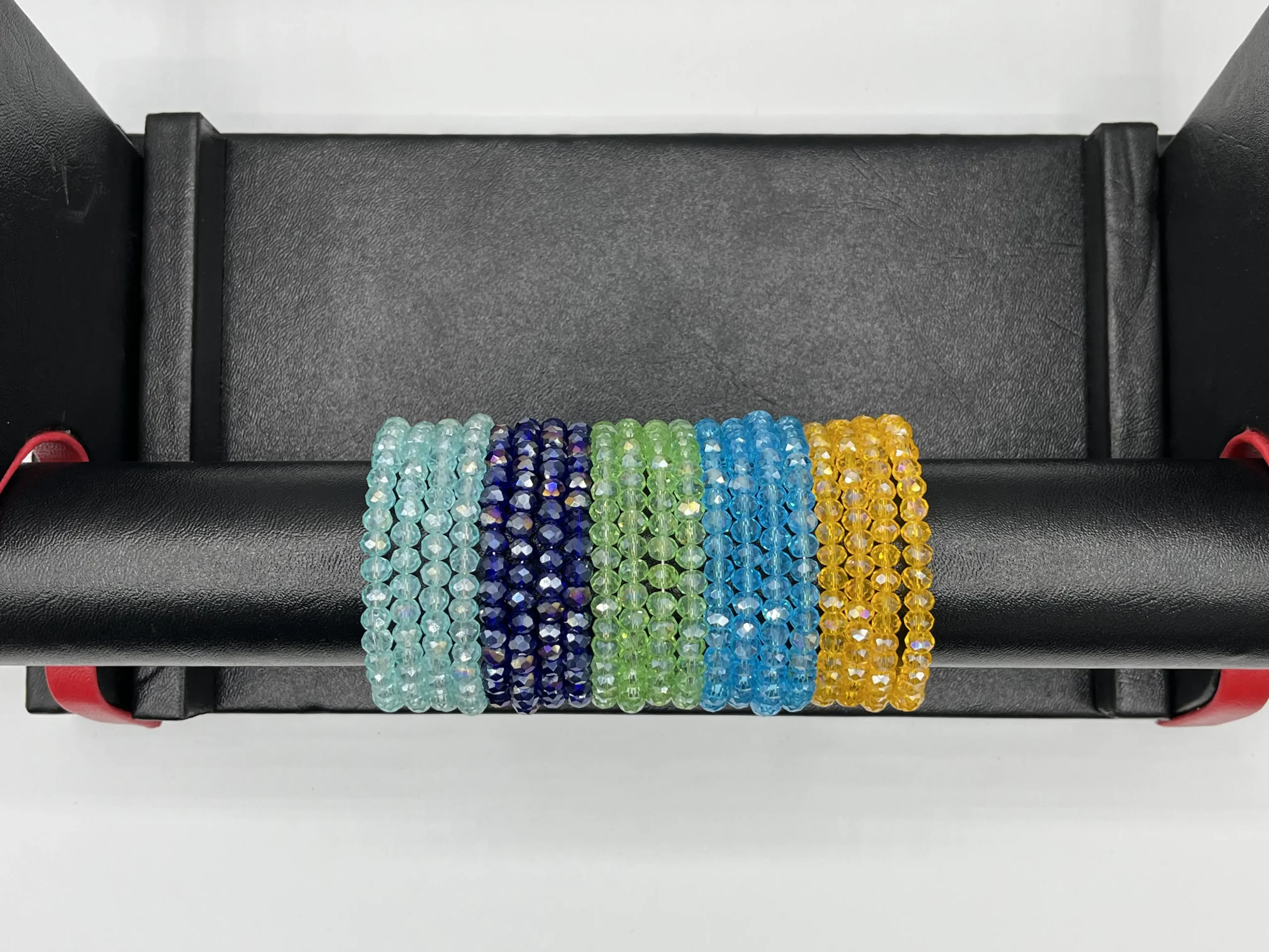 Sky blue and turquoise crystal beaded bangles stacked together on wrist showing layered jewelry styling