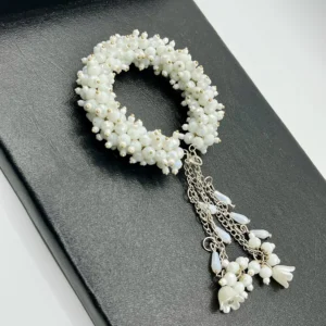 Close-up detail of white pearl beads and silver-tone alloy chains in handmade gajra bracelet showing craftsmanship