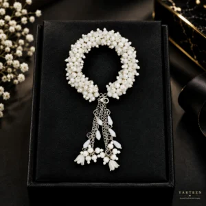 Elegant handmade white pearl gajra bracelet with hanging tassel chains and floral accents for bridal celebrations