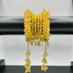 Close-up detail of yellow faceted crystal beads and silver chain accents in handmade gajra bracelet